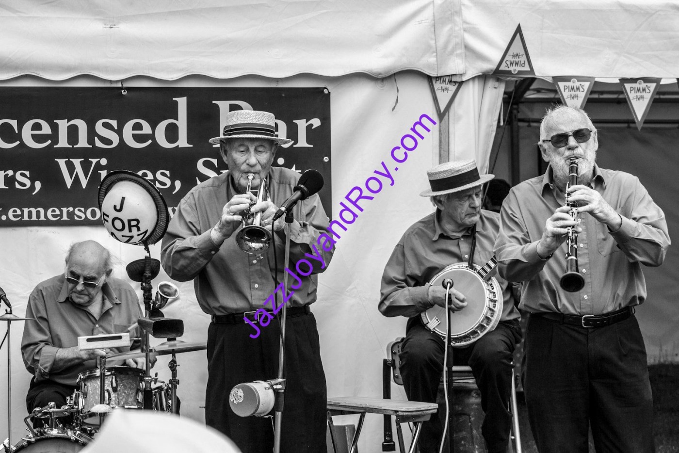 grayscale photo of group of people playing on stage